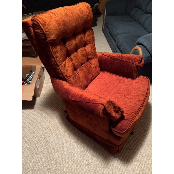 One blue fabric sofa with wood trim and one orange upholstered armchair with tufted back and wide ar