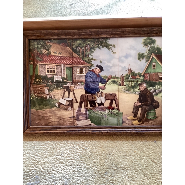 This is a vintage framed ceramic tile tray featuring artwork by the Dutch artist J.C. Van Hunnik. 
T