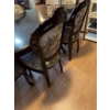 Image 9 : Dining set featuring an oval-shaped wooden table with dark finish and leaf extensions, accompanied b