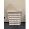 Image 1 : This white wall-mounted shelf is a decorative display unit, likely used for organizing small items s