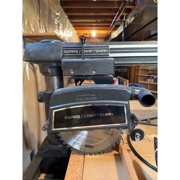  vintage Sears Craftsman 10-inch radial arm saw mounted on a metal stand with casters. 
Versatility:
