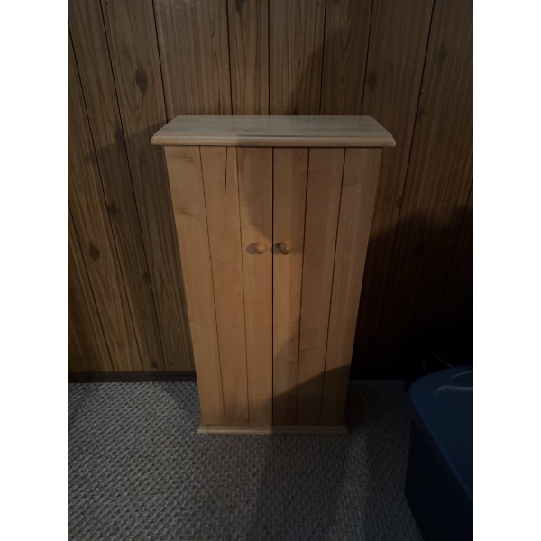 Wooden storage cabinet with double doors featuring interior shelving suitable for organizing CDs or 