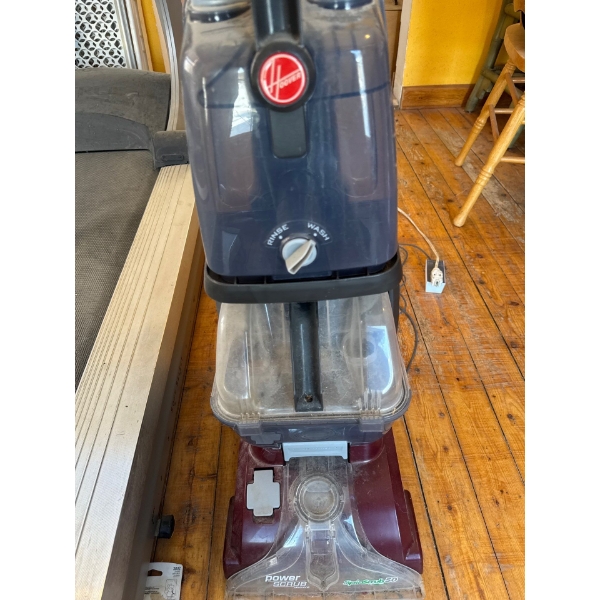 Hoover Power Scrub Deluxe Carpet Cleaner, which is designed to deeply clean carpets and upholstery. 