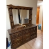Image 11 : This vintage-style wooden dresser features ornate carved drawer fronts, brass-colored handles, and a