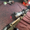 Image 7 : Ruger American bolt-action rifle chambered in 7mm-08 Rem. Features a green speckled synthetic stock,