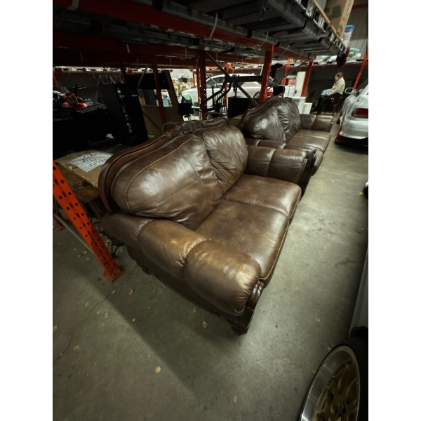 Leather two seater sofa. 69 inches long. By 37 inches wide.