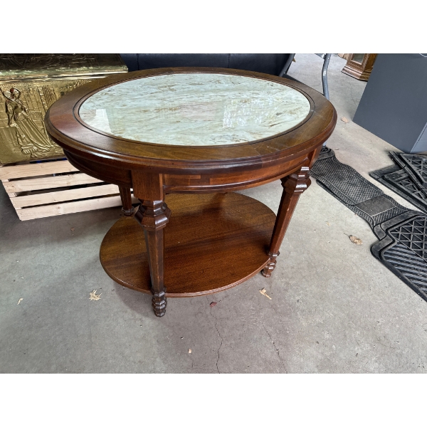 An oval mahogany coffee table with a green marble inset top