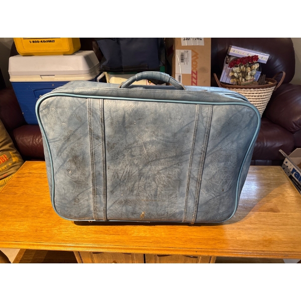  vintage leather suitcase with smaller compatible suitcase inside.
