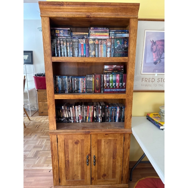  rustic-style wooden bookcase with lower storage cabinets. 
Features three upper open shelves for di