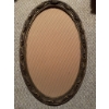Image 1 : Oval metal frame with decorative floral design, containing a black and white photographic portrait o