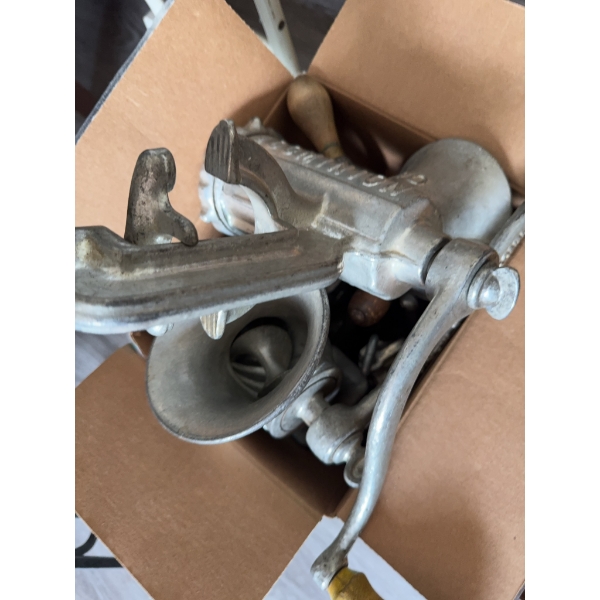 Various hand tools with wood handles such as brace drills, a manual meat grinder, and additional mix