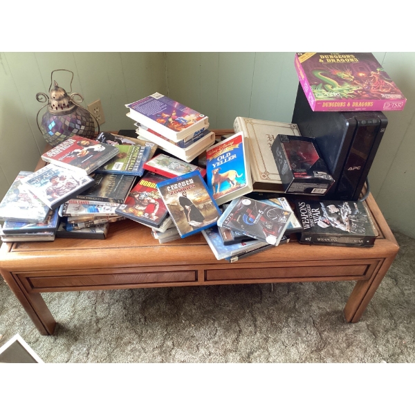 PS three games, DVDs, holy bible, gaming PC, and table. All items on table, including table include