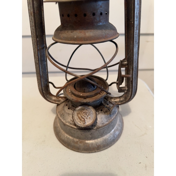Metal Dietz kerosene lantern. The lantern shows signs of use and age and includes an attached wire h
