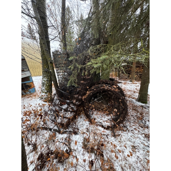 Large rolls of barbed wire and fencing material. Just the two, the barbed wire, and that one.