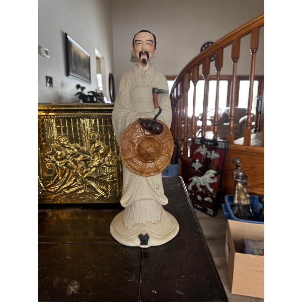  ceramic or porcelain figurine, likely of Chinese origin based on the marks visible on the bottom. 