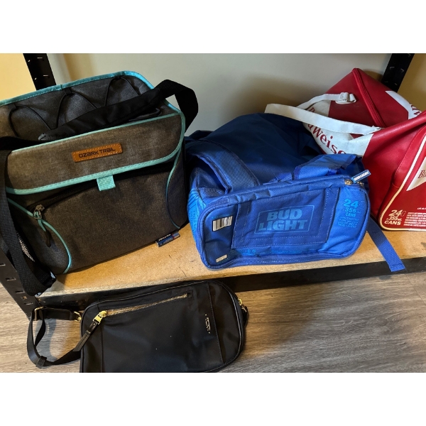 Vintage red Budweiser cooler, smaller blue Bud Light cooler, a Tumi shoulder strap bag and a Ozark b