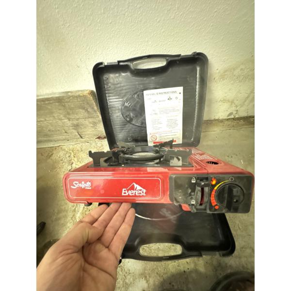 red Scripto Everest gas camping stove, designed for portable outdoor cooking. 