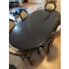 Image 7 : Dining set featuring an oval-shaped wooden table with dark finish and leaf extensions, accompanied b