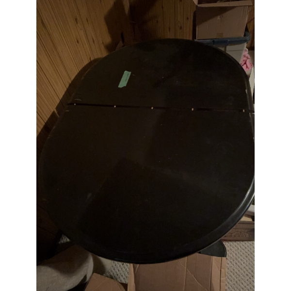 Dark wood oval dining table featuring a double pedestal base with four feet each. Includes three sep