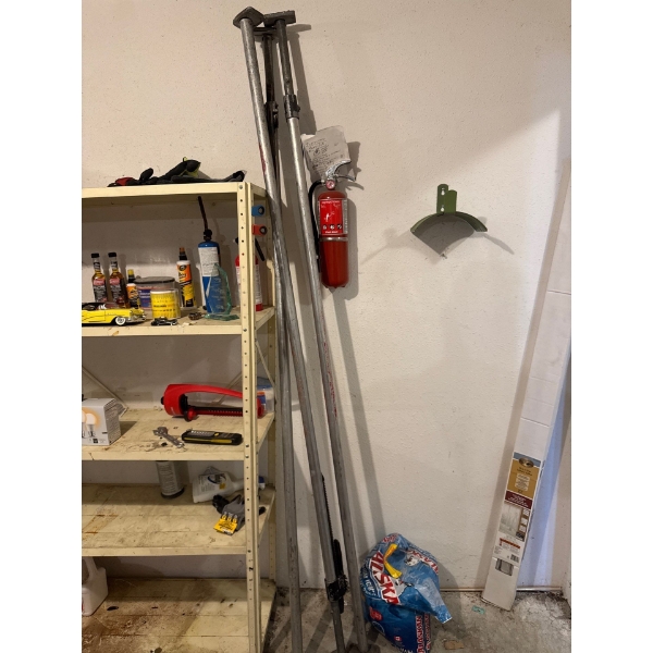 Three metal cargo jack bars or drywall hanging bars