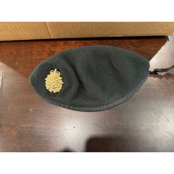  collectible Royal Canadian Navy green beret featuring a distinct metal badge. 