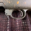 Image 13 : Ruger American bolt-action rifle chambered in 7mm-08 Rem. Features a green speckled synthetic stock,
