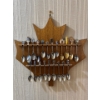 Image 1 : collection of Canadian souvenir spoons displayed on a maple leaf-shaped wooden rack. 
Souvenir spoon