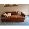 Image 1 :  terracotta-colored velvet or suede 3-seater sofa couch