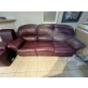 Image 5 : burgundy leather reclining sofa features a center console with built-in cup holders. 
