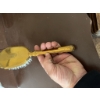 Image 5 : Gold-tone decorative hairbrush featuring ornate detailing on the back and handle and synthetic brist