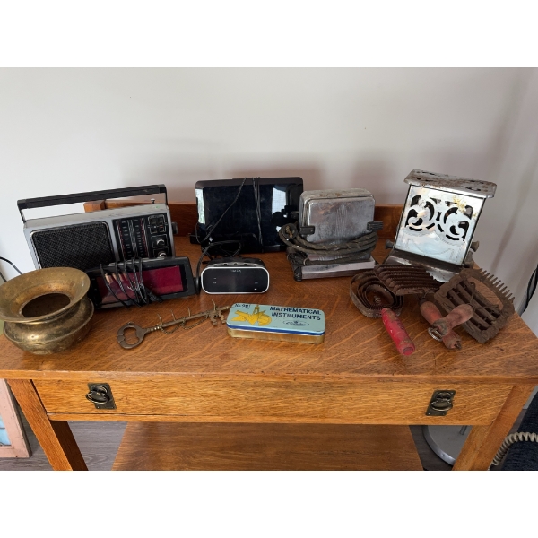 Two Old Hickory knives, a western rodeo-themed metal belt buckle, a wooden bar cart with casters and