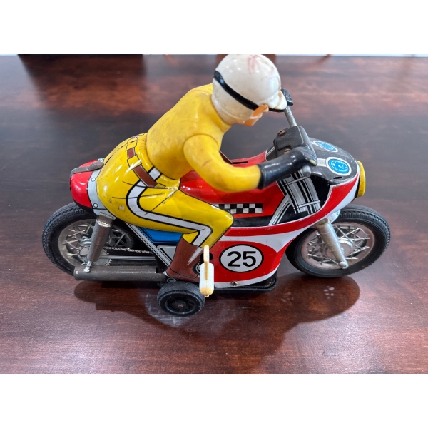  vintage tin toy motorcycle made by Daiya in Japan during the 1960s. 
It is a battery-operated toy, 