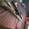 Image 6 : Ruger American bolt-action rifle chambered in 7mm-08 Rem. Features a green speckled synthetic stock,