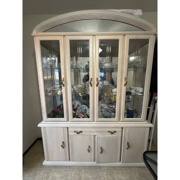 This is a lighted China or curio cabinet designed to display possessions. 
