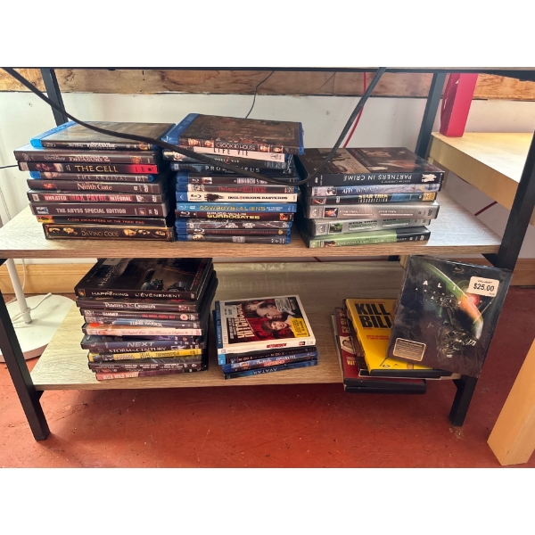 DVD collection and miniature TV stand. TV stand is 31 inches wide, 15 and a half inches deep by 24 i