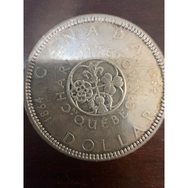 1964 Canadian silver dollar commemorating the Charlottetown and Quebec Conferences. Features Queen E
