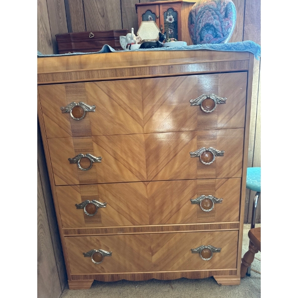 This is an Art Deco waterfall highboy dresser from the 1920s or 1940s. 
