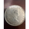 Image 3 : 1960 Canadian 50 cent coin featuring the coat of arms and a portrait of Queen Elizabeth II. The coin