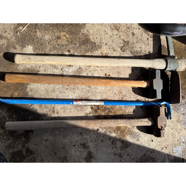  collection of vintage manual tools, including a post maul and a wrecking bar.
Vintage Post Maul: A 