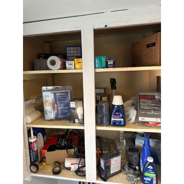 All items in left cabinet in laundry room, items include Bissell cleaner, tin foil, lightbulbs and e