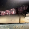 Image 18 : Ruger American bolt-action rifle chambered in 7mm-08 Rem. Features a green speckled synthetic stock,