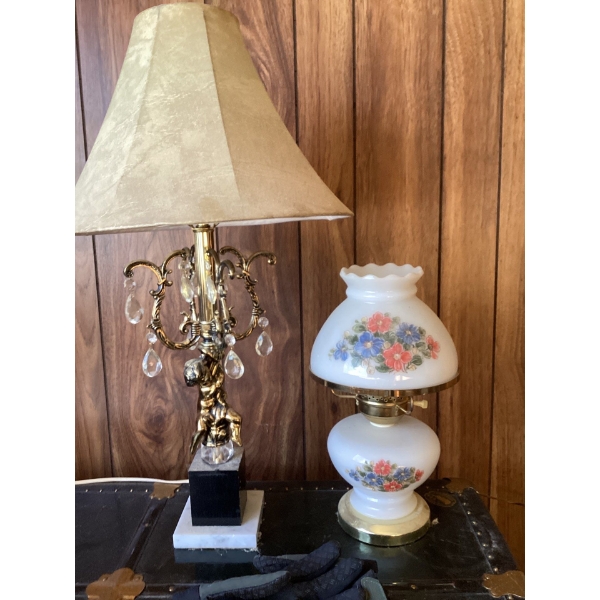 The brass and crystal lamp is a vintage Hollywood Regency style cherub lamp, likely from the 1960s. 