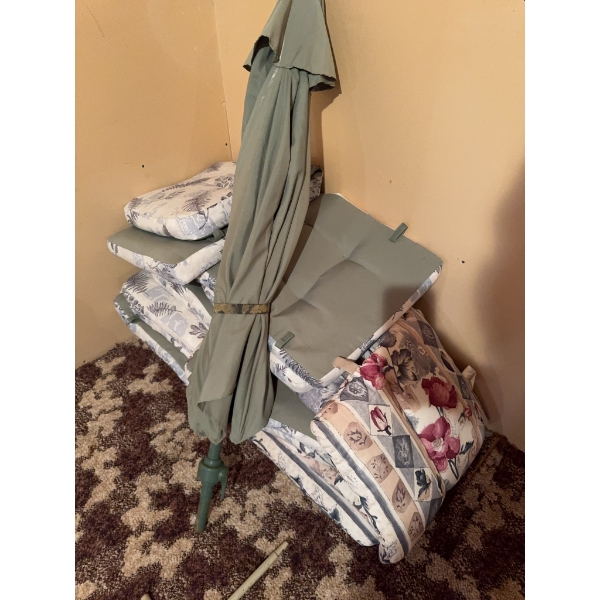 One green patio umbrella and a selection of outdoor seat and back cushions with floral and patterned