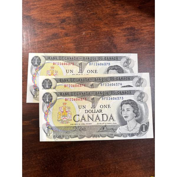 consecutive vintage 1973 Canadian one-dollar banknotes from the "Scenes of Canada" series, featuring