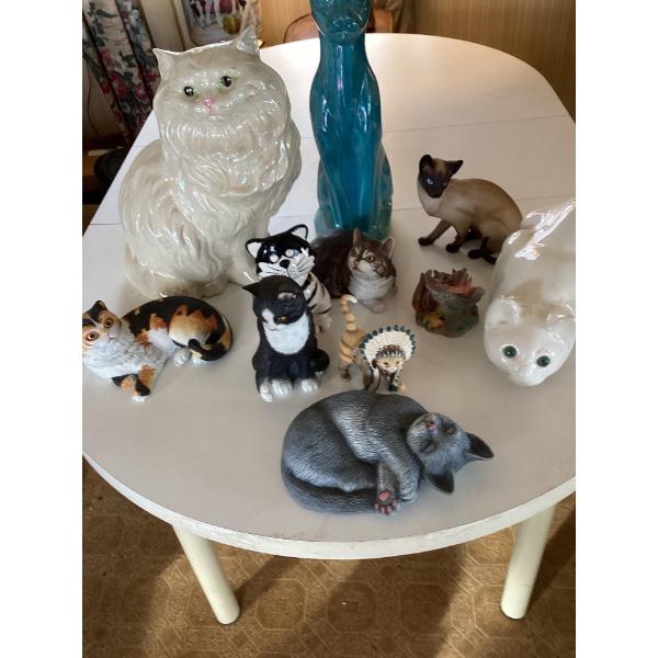  collection of various ceramic cat figurines.The figurines include a large whi