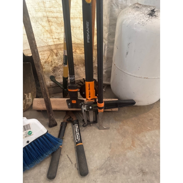 Four Fisker tools, one weed puller, one shop sweep broom, one cutter, extendable cutter. One Fisker'