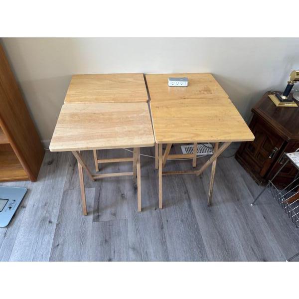 Four folding wood TV dinner stands, 19 inches wide by 14 and a half inches deep by 26 inches high