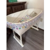 Image 3 : White wicker baby bassinet with folding legs, lace trim, fitted colorful smiley face fabric, and thr