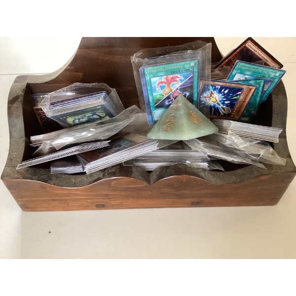 This is a collection of Yu-Gi-Oh! Trading Card Game cards in a wooden box. The items shown are part 
