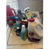 Image 1 : Bottles of  cleaning supplies such as hoover carpet cleaner, lysol wipes, and Bissel